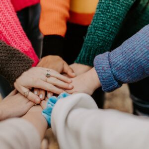 A group of people all holding hands.